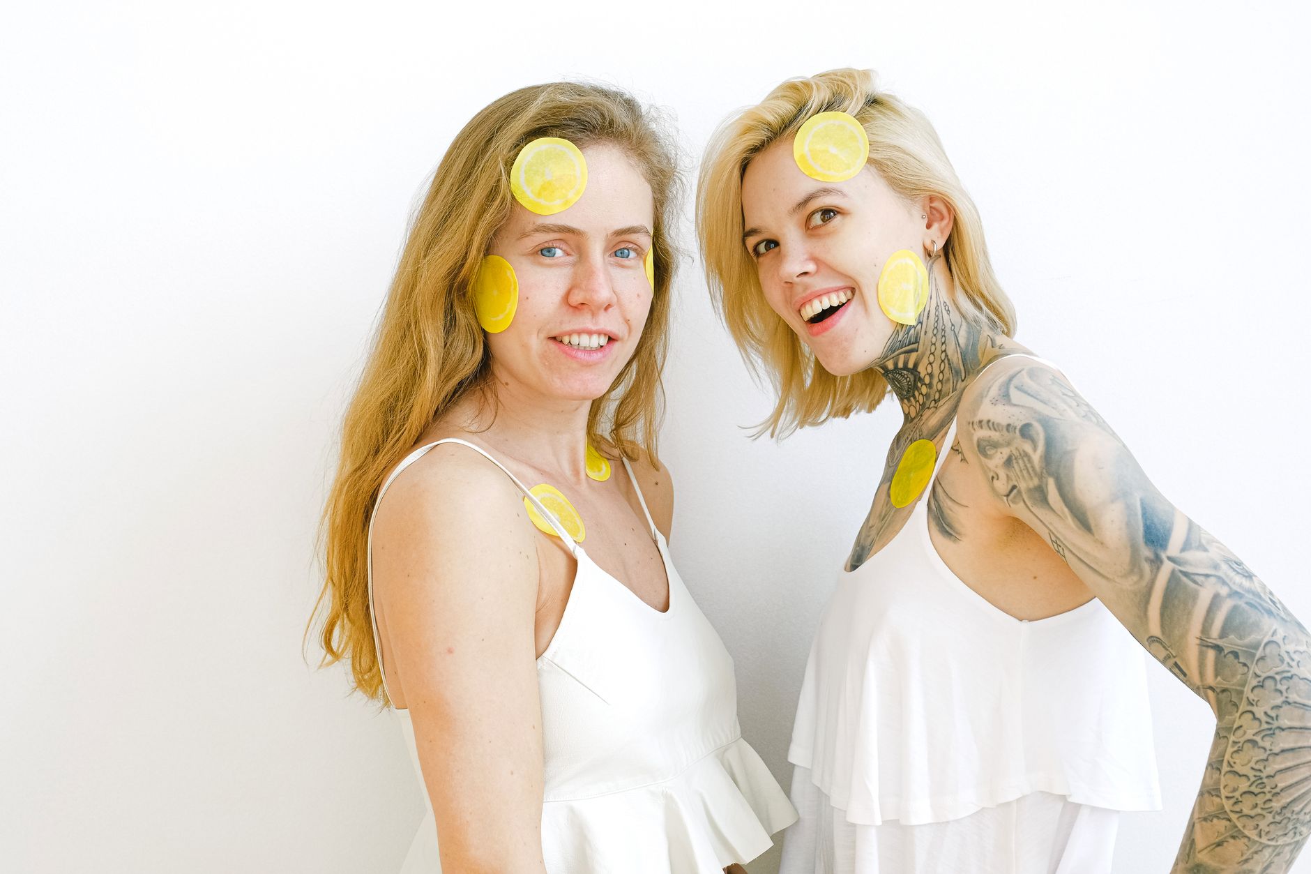 Bright yellow lemons arranged on a pastel green background, symbolizing renewal and fresh sensation